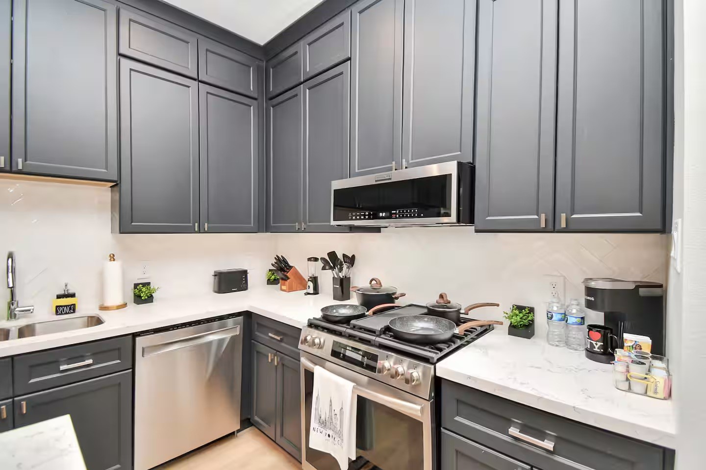 5718 Beall Street, Unit D Houston, TX 77091 - Photo 7 of 41 a kitchen with stainless steel appliances a sink dishwasher stove top oven and cabinets with wooden floor