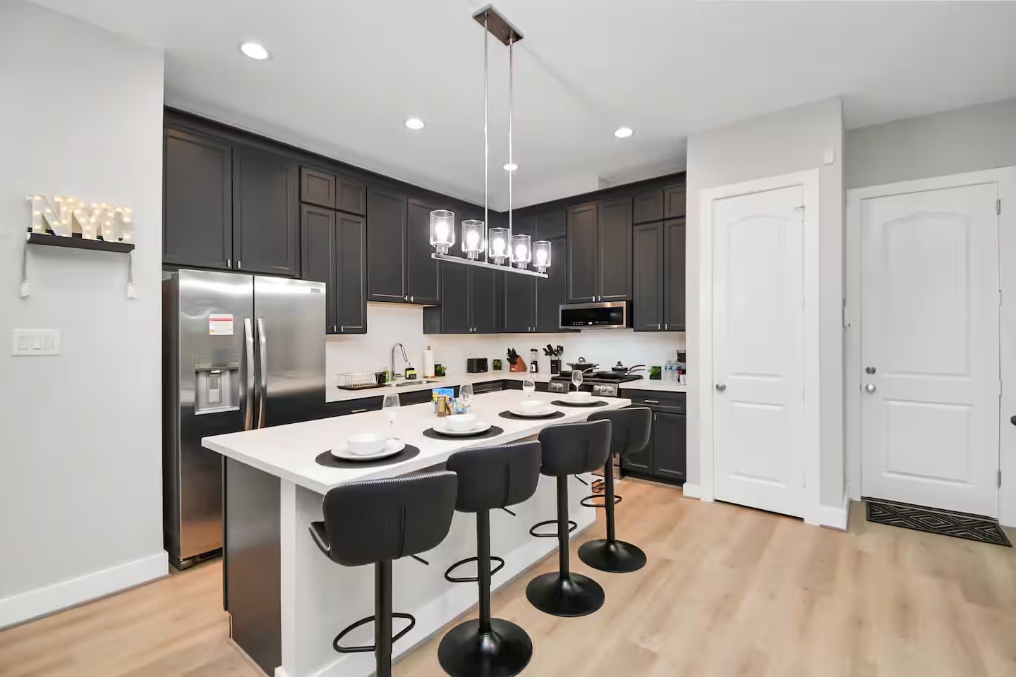 5718 Beall Street, Unit D Houston, TX 77091 - Photo 8 of 41 a kitchen with refrigerator and chairs