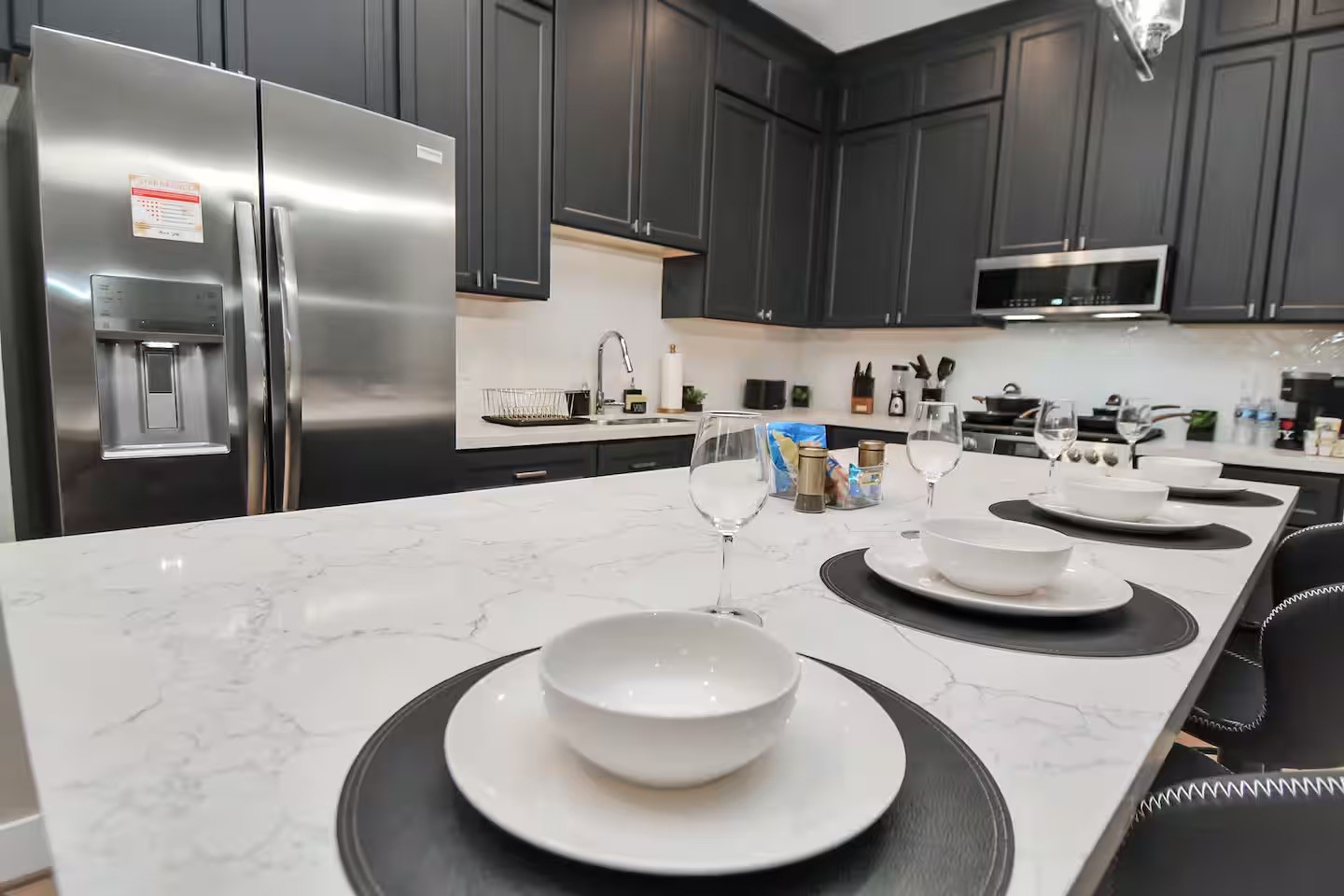 5718 Beall Street, Unit D Houston, TX 77091 - Photo 10 of 41 a kitchen with stainless steel appliances kitchen island granite countertop a sink a microwave and chairs