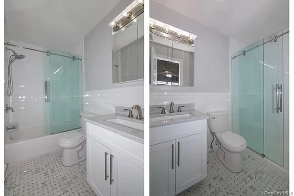 a view of bathroom with a toilet sink and mirror