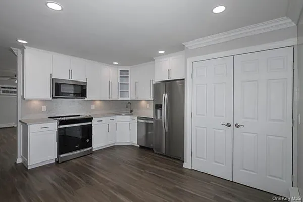 a kitchen with a sink stainless steel appliances and cabinets