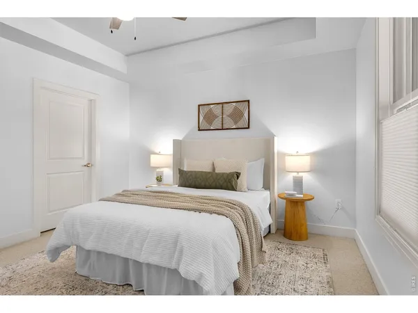 a bedroom with a bed and a lamp