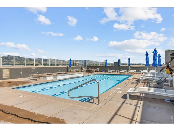a large bedroom with a bed and a large window