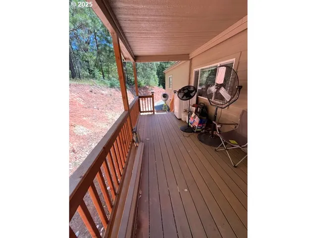 a view of a couches and dinning table in a balcony