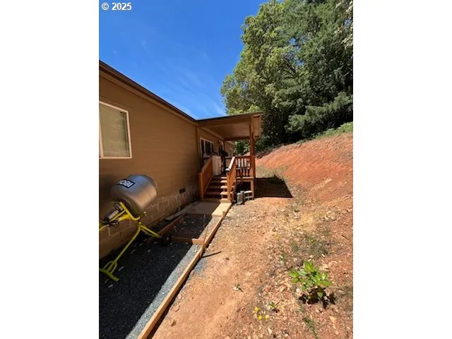 a backyard of a house with table and chairs