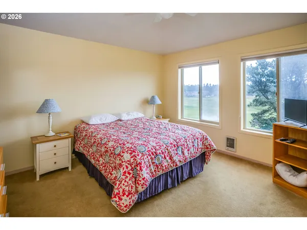 a bedroom with a bed and a lamp