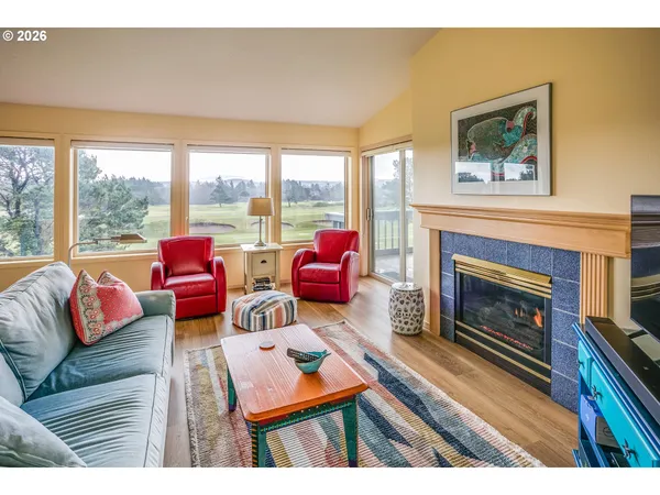 a open kitchen with granite countertop a stove a sink dishwasher and white cabinets with wooden floor