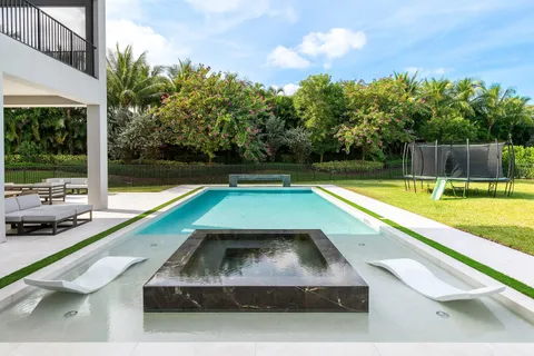 a view of swimming pool with chairs
