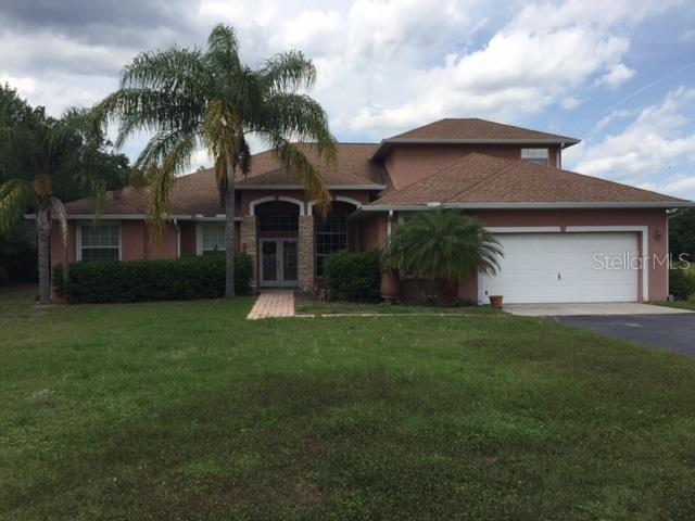 15529 West County Line Road Odessa, FL 33556 - Photo 1 of 1 a front view of house with a garden
