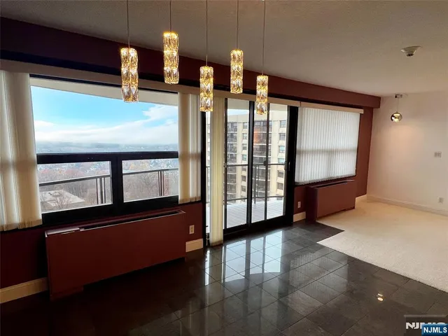 an empty room with fireplace and windows