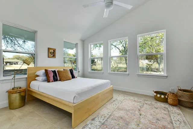 a bedroom with a large bed and a window