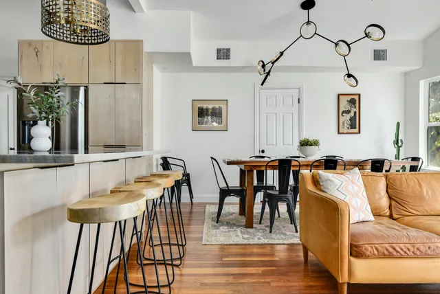 a kitchen with stainless steel appliances granite countertop a refrigerator a oven and a sink