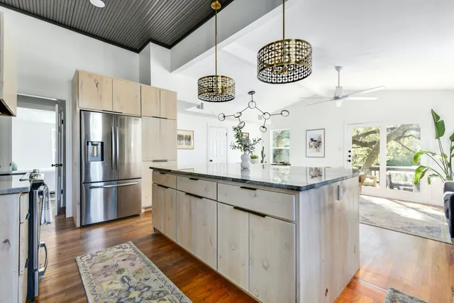 a living room with furniture a dining table and chandelier