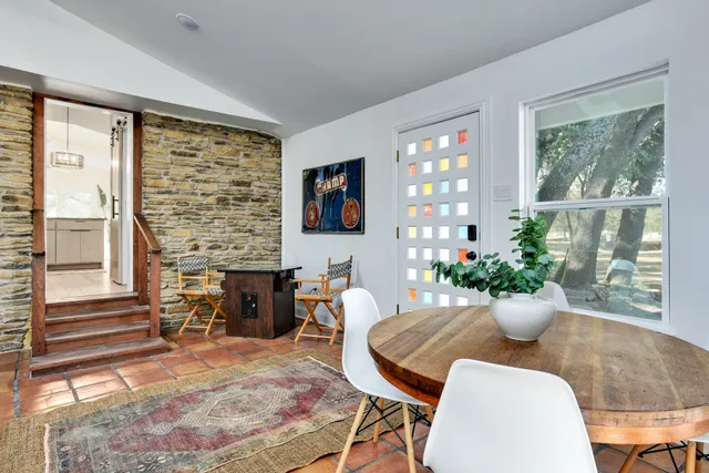 a view of a dining room with furniture and a chandelier