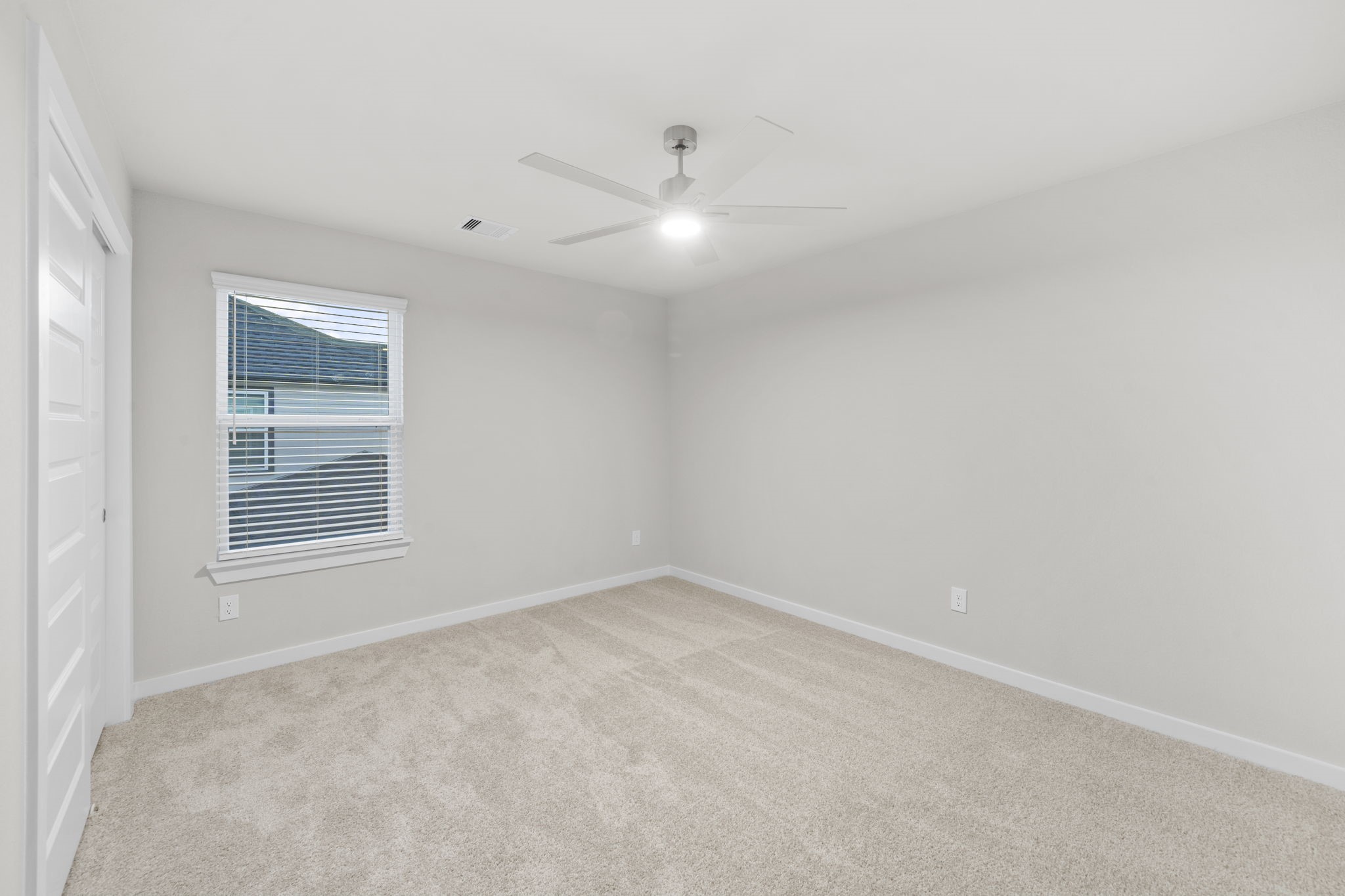 3015 Boulder Ridge Drive Rosenberg, TX 77471 - Photo 26 of 34 an empty room with windows and fan