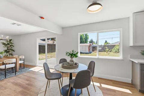 a view of a dining room with furniture window and outside view