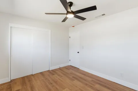 a view of a room with wooden floor