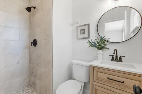 a bathroom with a sink toilet and a mirror