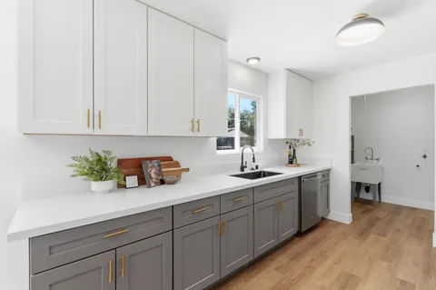 a kitchen with sink and cabinets