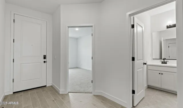 a bathroom with a toilet sink a mirror and shower