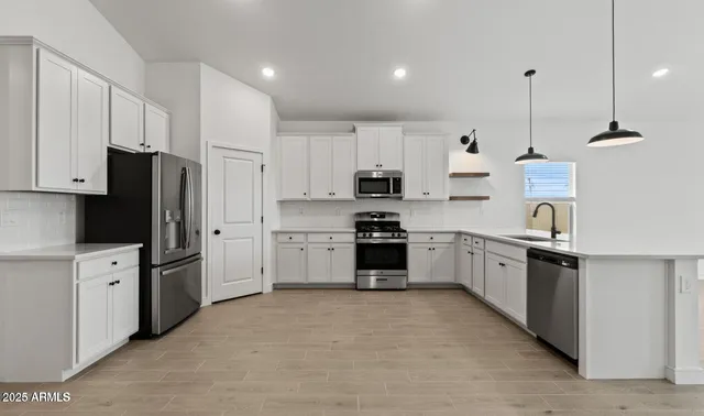 a kitchen with stainless steel appliances and white cabinets