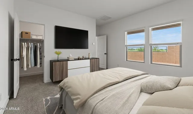 a bedroom with a bed and a flat screen tv