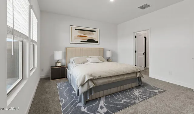 a bedroom with a bed and a window