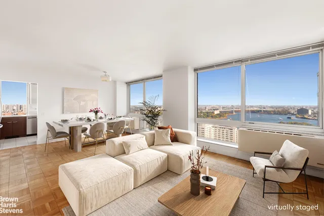 a living room with furniture and floor to ceiling window