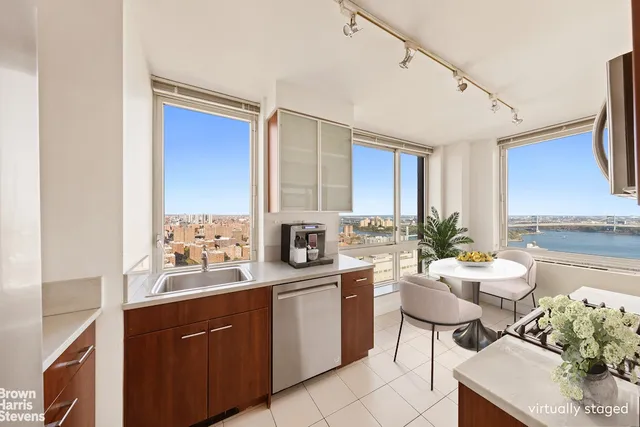 a room with a sink stove and chairs