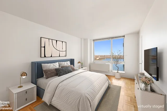 a bedroom with a bed and a flat screen tv