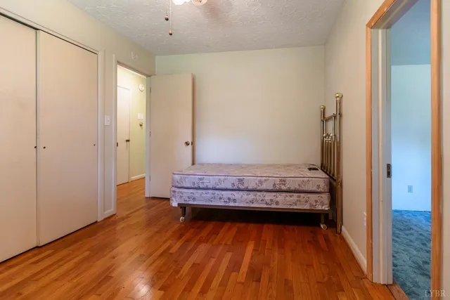 a view of a room with wooden floor and bench
