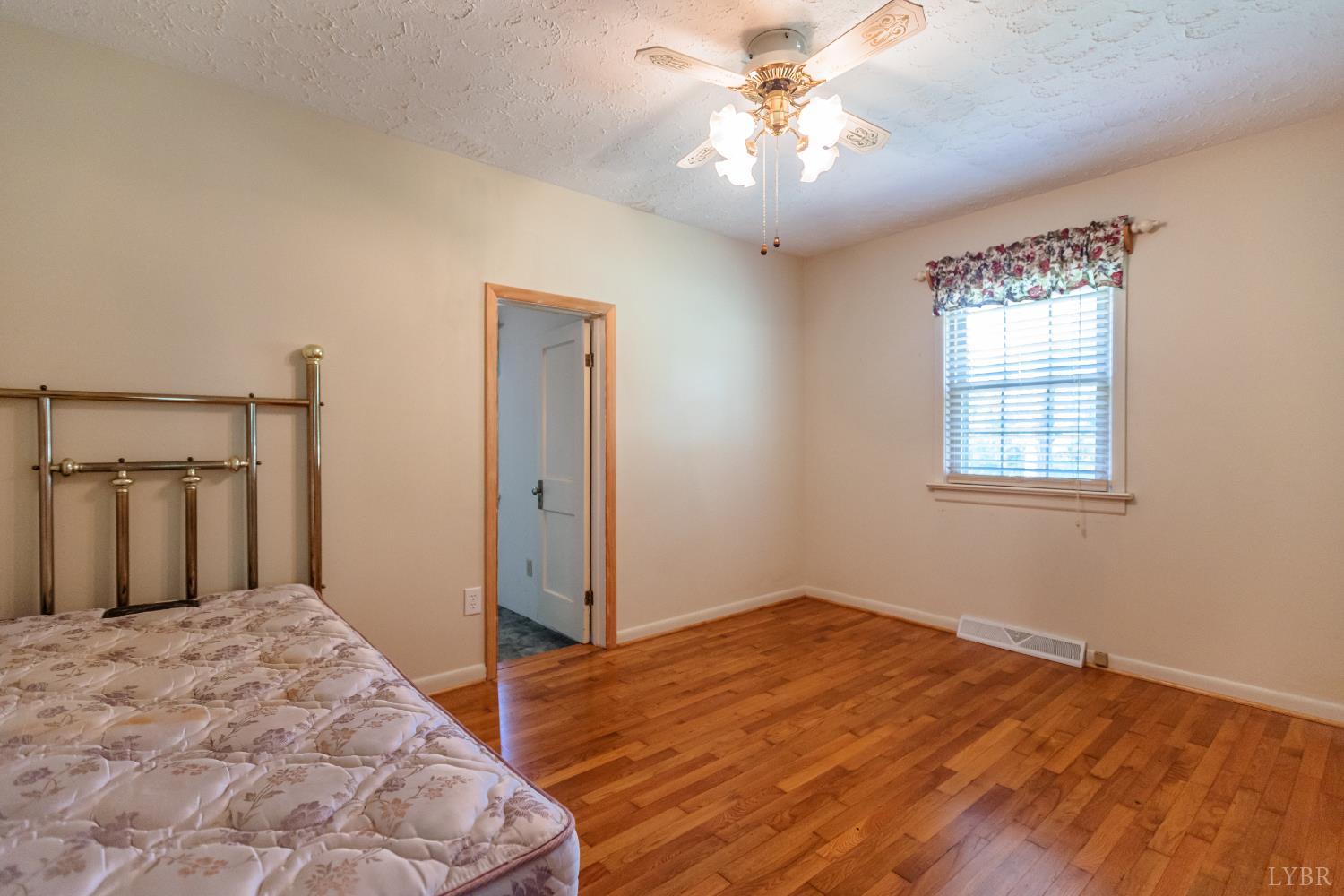 1338 Wickliffe Road Brookneal, VA 24528 - Photo 16 of 24 a bedroom with a bed and a window