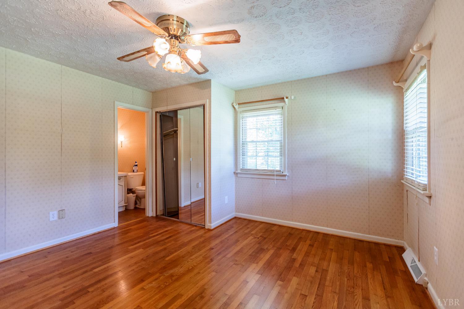 1338 Wickliffe Road Brookneal, VA 24528 - Photo 18 of 24 wooden floor in an empty room with a window