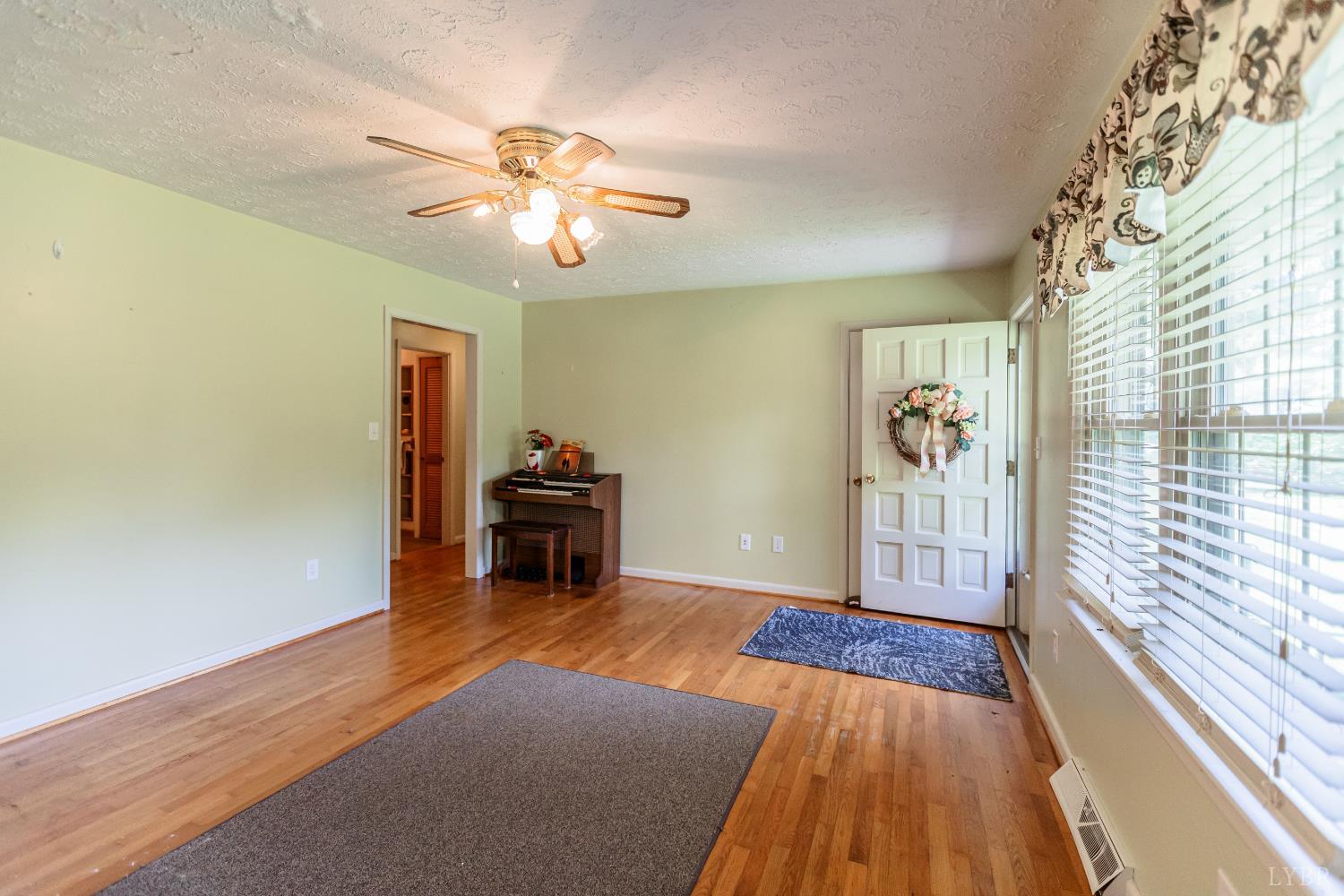 1338 Wickliffe Road Brookneal, VA 24528 - Photo 3 of 24 wooden floor in an empty room with a window