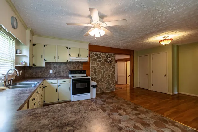 a kitchen with a stove a sink and a refrigerator