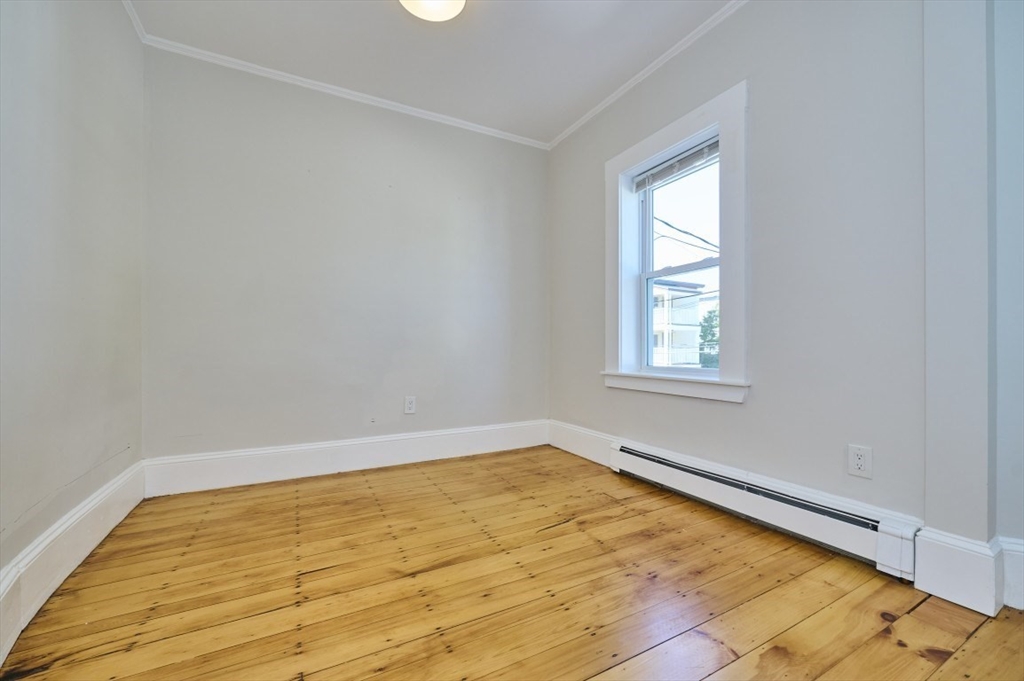 67 Wheatland Street, Unit 2 Somerville, MA 02145 - Photo 13 of 19 a view of empty room with wooden floor