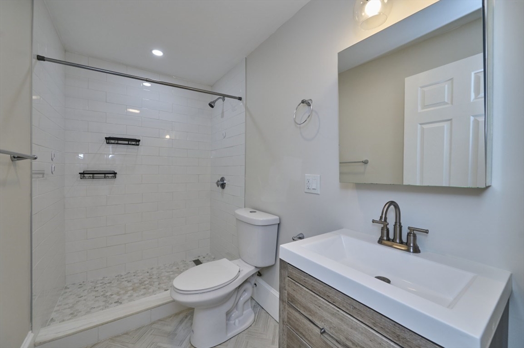 67 Wheatland Street, Unit 2 Somerville, MA 02145 - Photo 14 of 19 a bathroom with a sink a toilet and shower