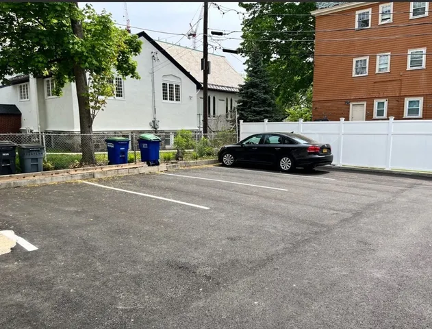 a car parked in front of a white house