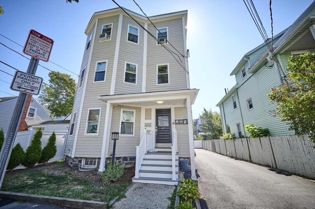 67 Wheatland Street, Unit 2 Somerville, MA 02145 - Photo 18 of 19 a front view of a house with a yard