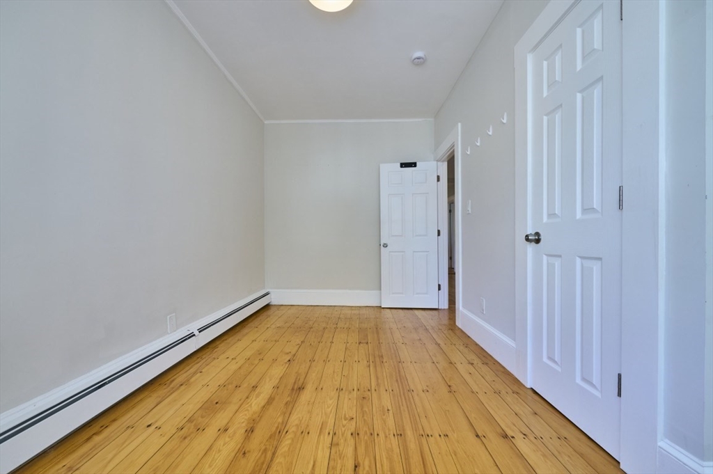67 Wheatland Street, Unit 2 Somerville, MA 02145 - Photo 10 of 19 a view of a room with wooden floor and a window