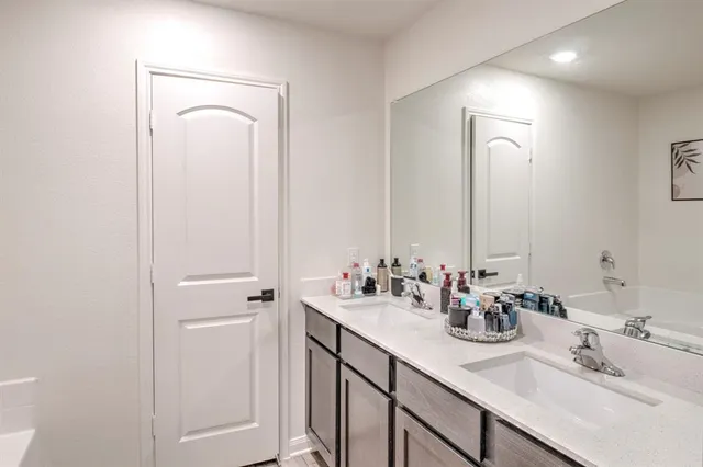 a bathroom with a bathtub and a shower