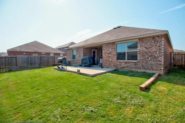 a view of a house with pool porch and wooden fence