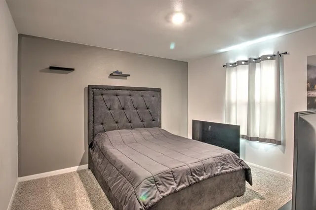 a bedroom with a bed and a window