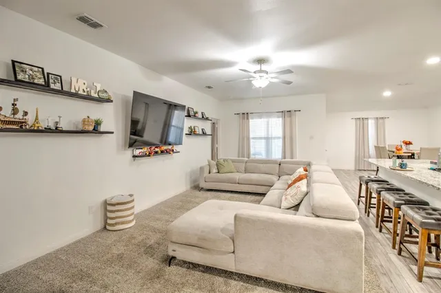 a living room with furniture and a chandelier