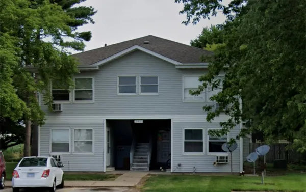 a front view of a house with a garden