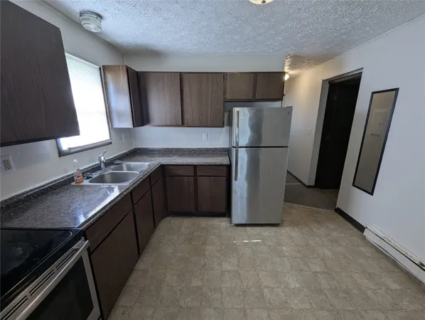 a kitchen with a refrigerator sink and stove