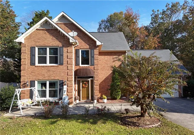 a front view of a house with a yard garage and outdoor seating
