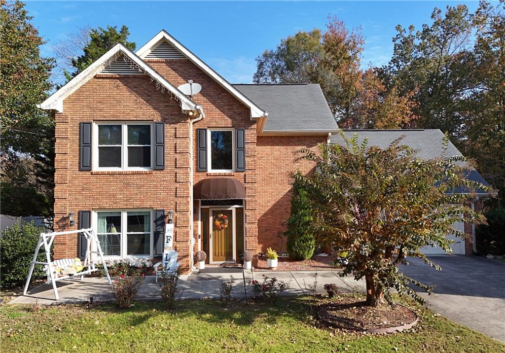 a front view of a house with a yard garage and outdoor seating