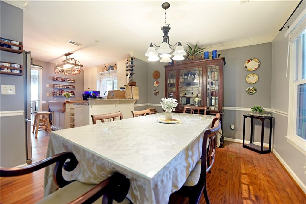 107 East Clinton Drive Southwest Rome, GA 30165 - Photo 14 of 38 a view of a dining room with furniture and a chandelier