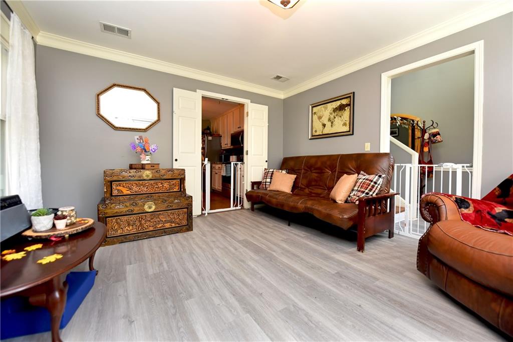 107 East Clinton Drive Southwest Rome, GA 30165 - Photo 16 of 38 a living room with furniture and a wooden floor